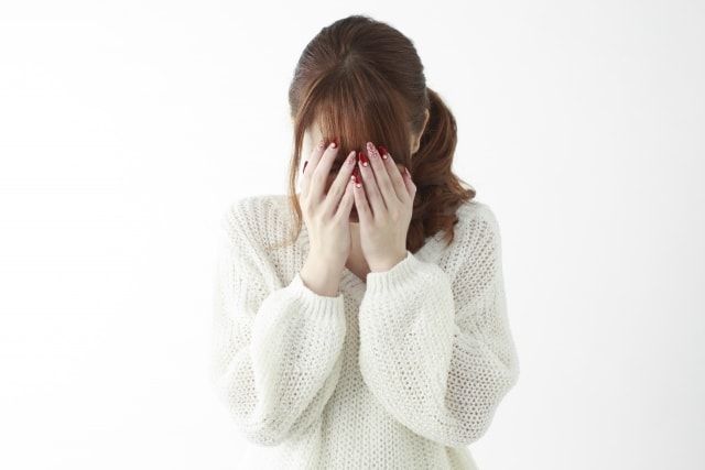 目を覆う人